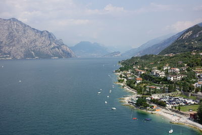 Scenic view of sea by city against sky