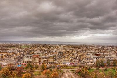 Cityscape against cloudy sky