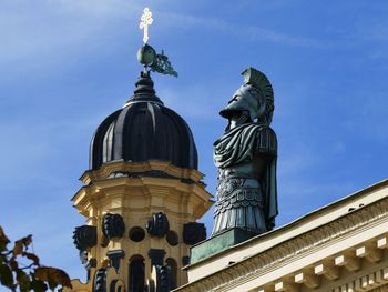 Low angle view of statue against blue sky