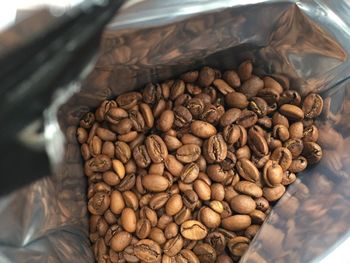 Close-up of roasted coffee beans in bag