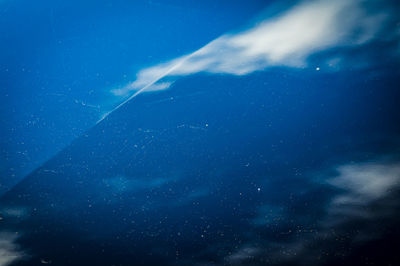 Low angle view of sea against blue sky