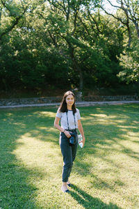 Portrait of girl standing on grassy field