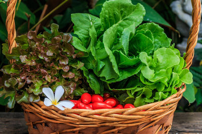 Fresh vegetables in wicker basket on table