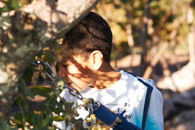 Close-up of boy by plants