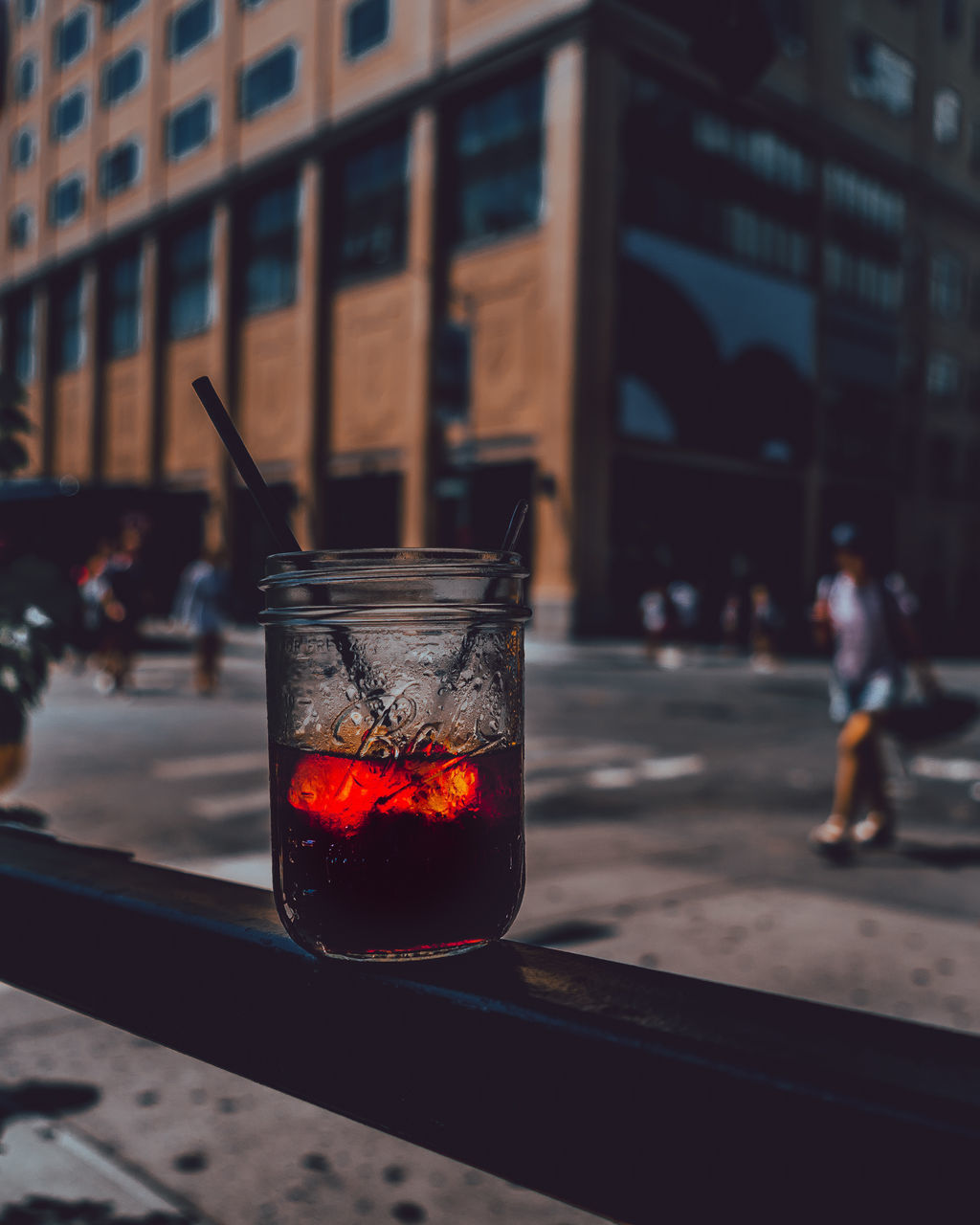 CLOSE-UP OF DRINK ON GLASS TABLE