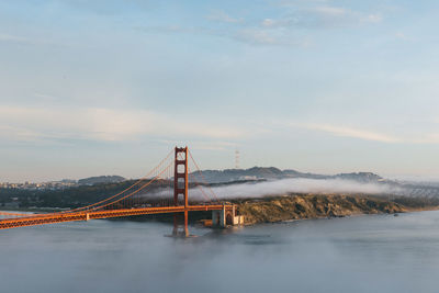 High angle view of suspension bridge against cloudy sky