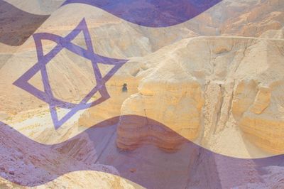 Israeli flag over desert in israel