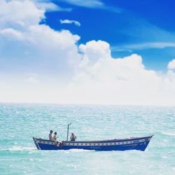 Boat sailing in sea against sky