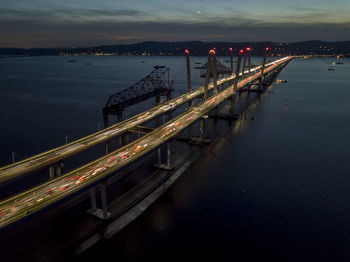 High angle view of bridge over sea against sky at night