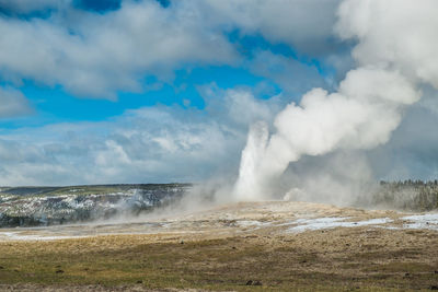 Scenic view of waterfall against sky