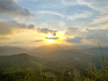 Scenic view of field against sky during sunset