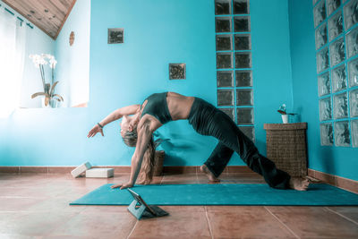 Man with arms raised on floor