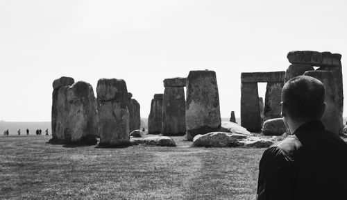 Rear view of man looking at old ruins