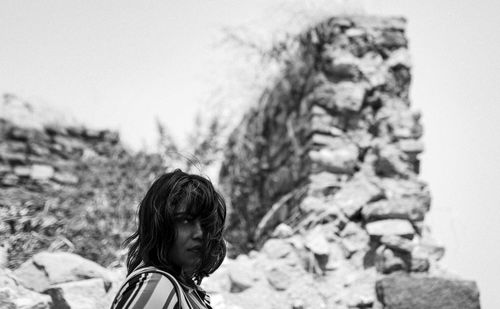 Portrait of girl on land against sky