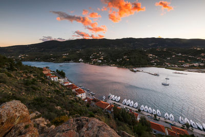 High angle view of buildings by sea against sky