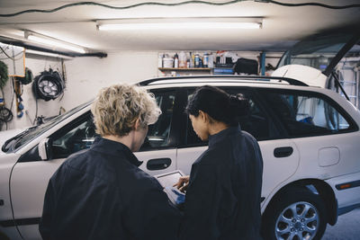 Rear view of people standing in car