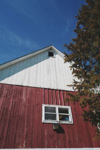 Low angle view of vintage barn against sky