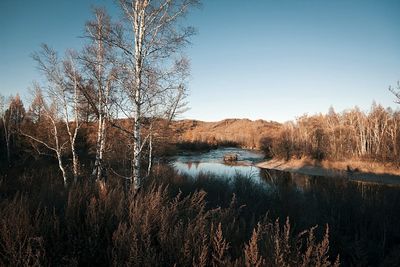 Scenic view of calm lake against clear sky