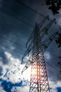 Low angle view of electricity pylon against sky