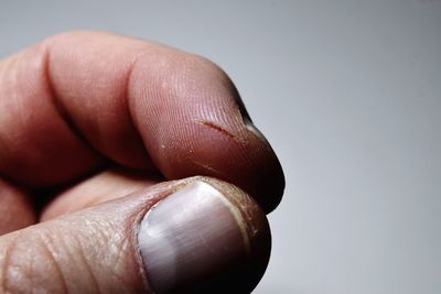 Close-up of hands over white background