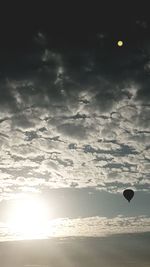 Silhouette hot air balloons against sky during sunset