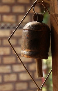 Close-up of bell hanging indoors