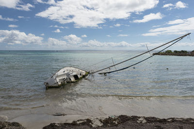 Boats moored on sea against sky