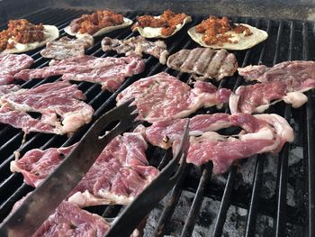 High angle view of meat on barbecue grill