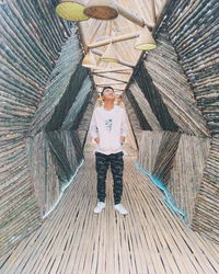 Portrait of young man standing on wood