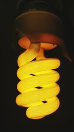 Close-up of yellow illuminated light against black background