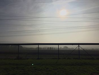Scenic view of field against sky at sunset