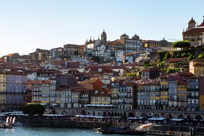 Buildings in city against clear sky