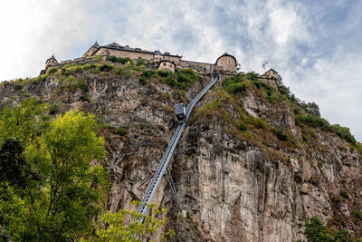 Low angle view of castle on mountain against sky