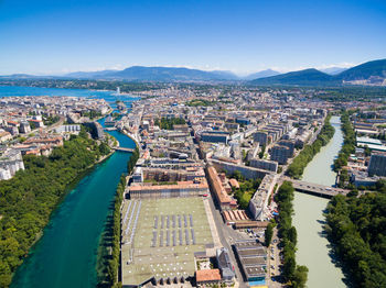 High angle view of buildings and trees against blue sky