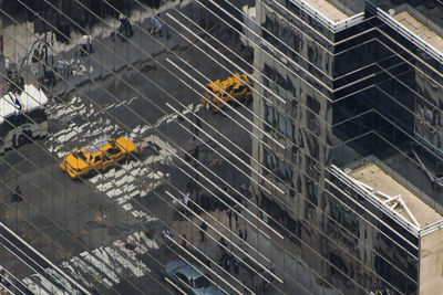 Manhattan, new york street reflection into a huge mirror building wall distorting reality.