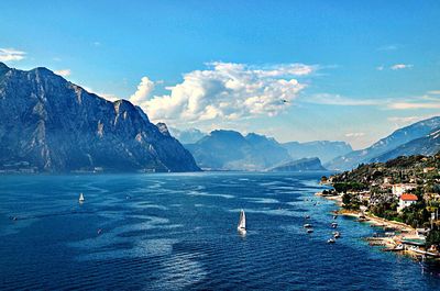 Scenic view of sea and mountains against sky