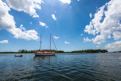 Sailboat sailing on sea against sky