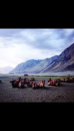 Scenic view of mountains against cloudy sky