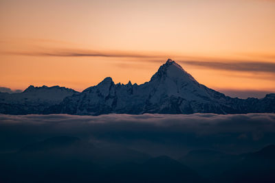 Scenic view of snowcapped mountains against sky during sunset