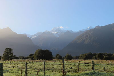 Scenic view of landscape and mountains against sky