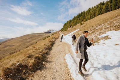 Rear view of man walking on mountain