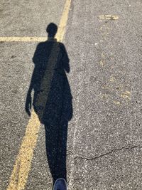 Shadow of person on road