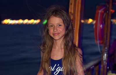 Portrait of smiling girl at night