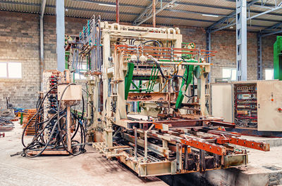 A large machine for making paving stones. disassembled industrial equipment in the workshop