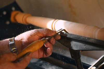 Close-up of person working on barbecue grill