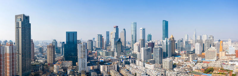 Aerial view of modern buildings in city against sky