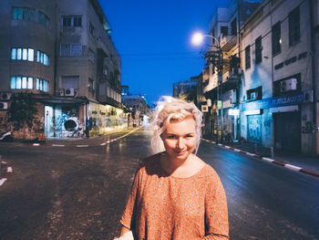 Portrait of woman standing on railing