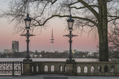 Germany, hamburg, street lights of schwanenwikbrucke bridge at dusk