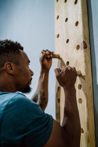 Close-up portrait of man holding wood