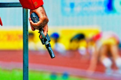 Cropped hand holding gun during race